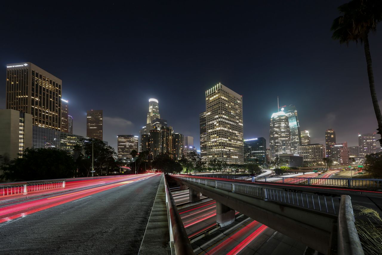 Vibrant long exposure of Downtown Los Angeles skyscrapers at night, showcasing the city skyline.